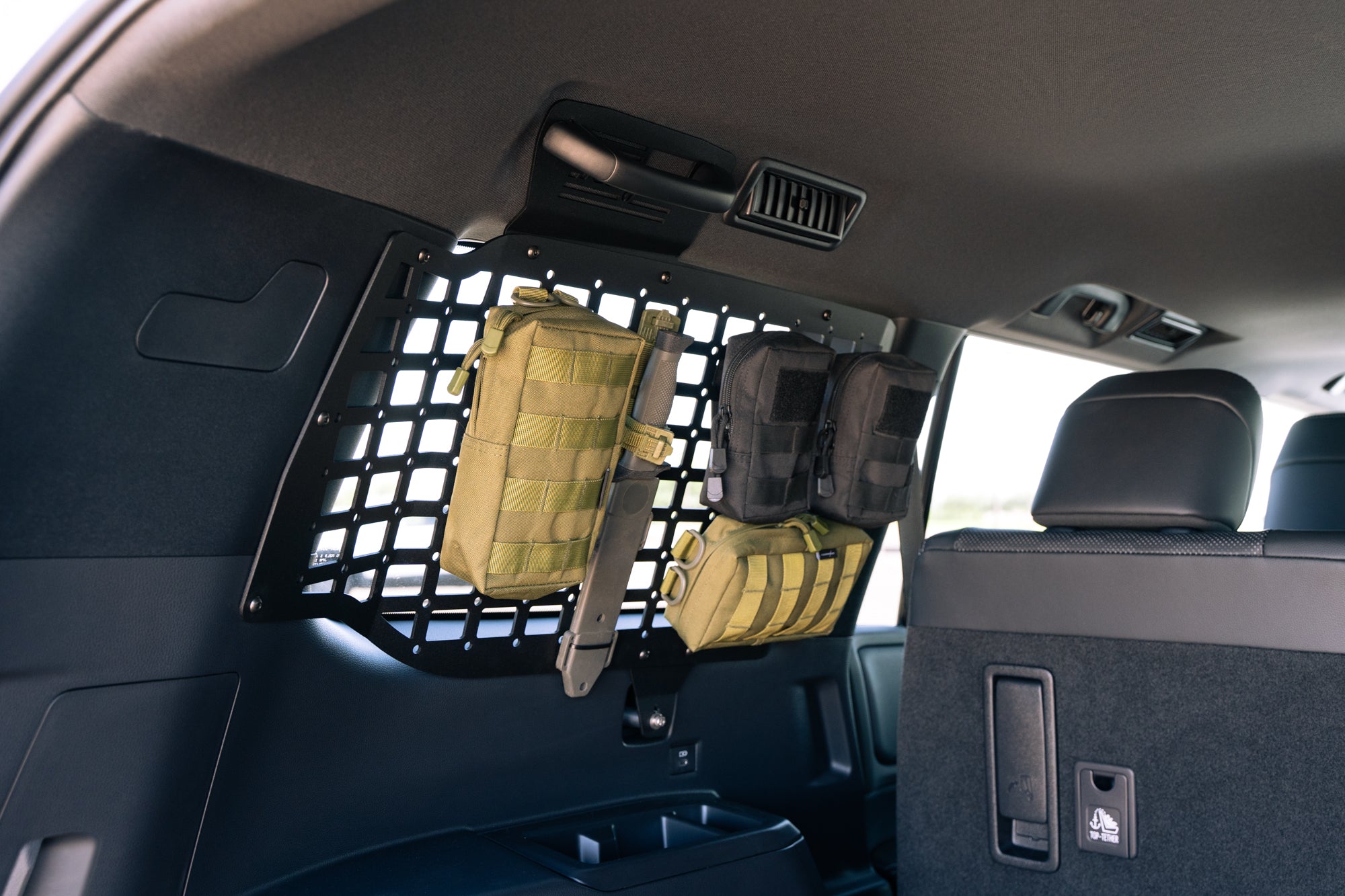 Molle bags and knife on the 2024 Toyota Land Cruiser Rear Window Molle Storage Panels