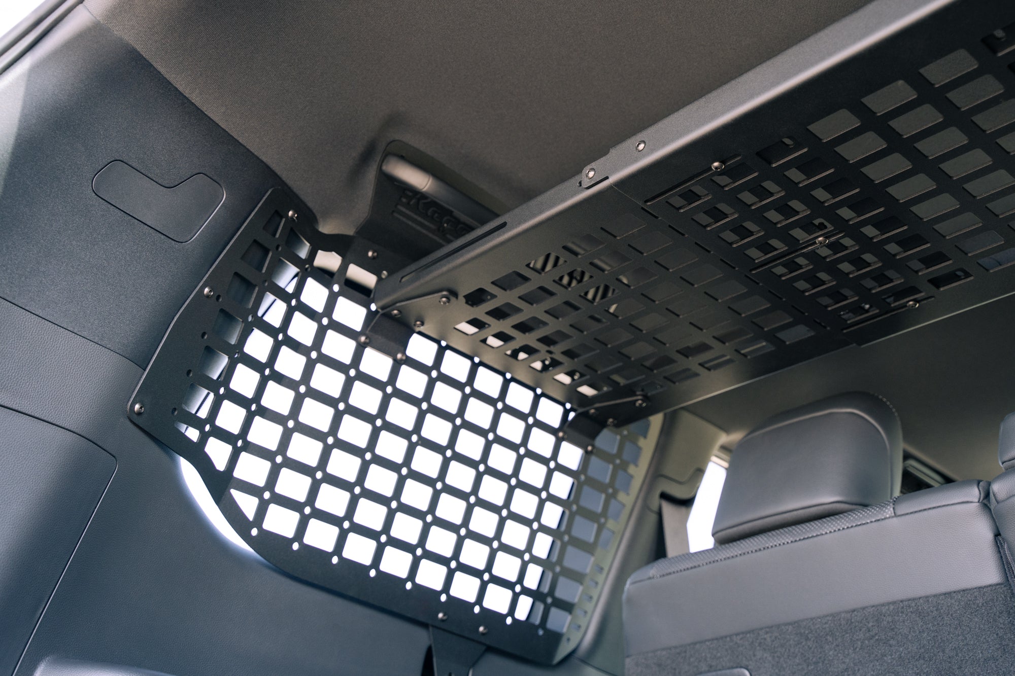 Seats reclined with the Molle Panel Storage Shelf for the 2024 Toyota Land Cruiser